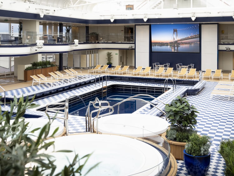 Daytime view of Queen Anne's Pavilion venue, showing pool, dual-deck seating and cinema screen