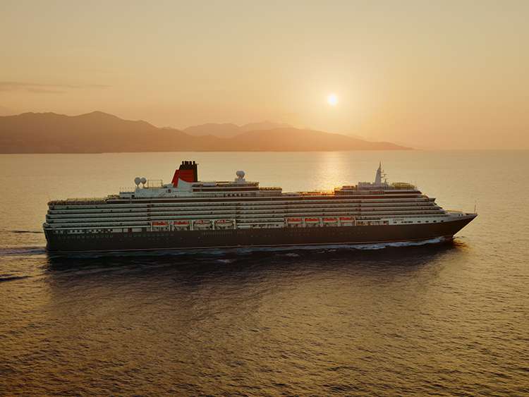 Queen Victoria at sea at sunset in the Mediterranean