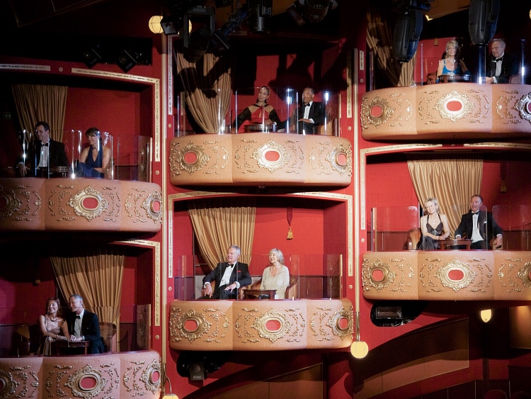 Six couples watch a show from in theatre boxes in Queen Victoria's Royal Court Theatre