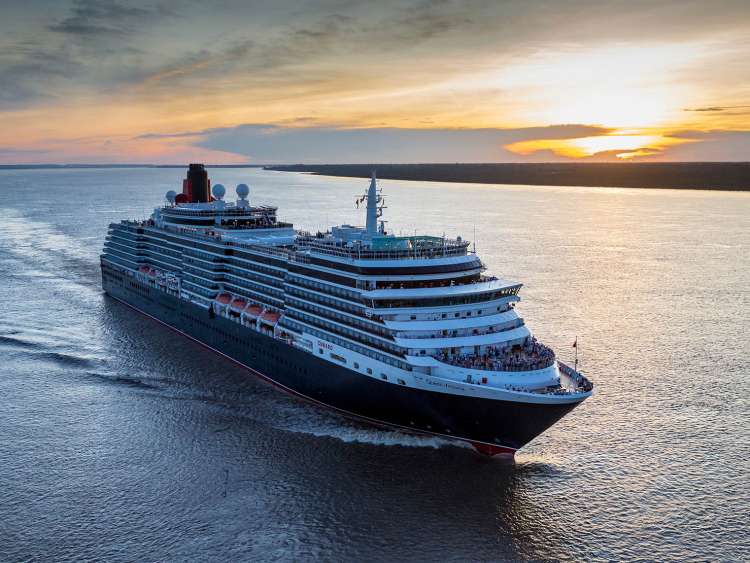 Queen Victoria sailing at sunset