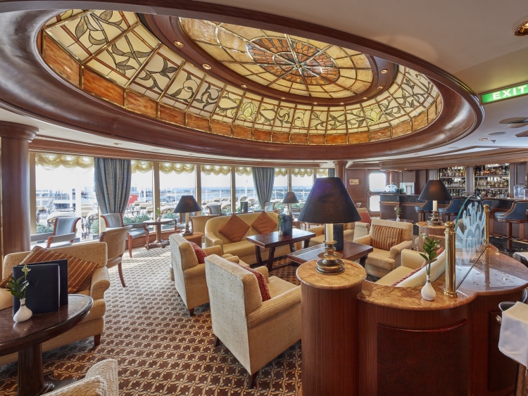 Queen Victoria's Grills Lounge, including art deco ceiling feature, seating areas, bar, and Grills deck access